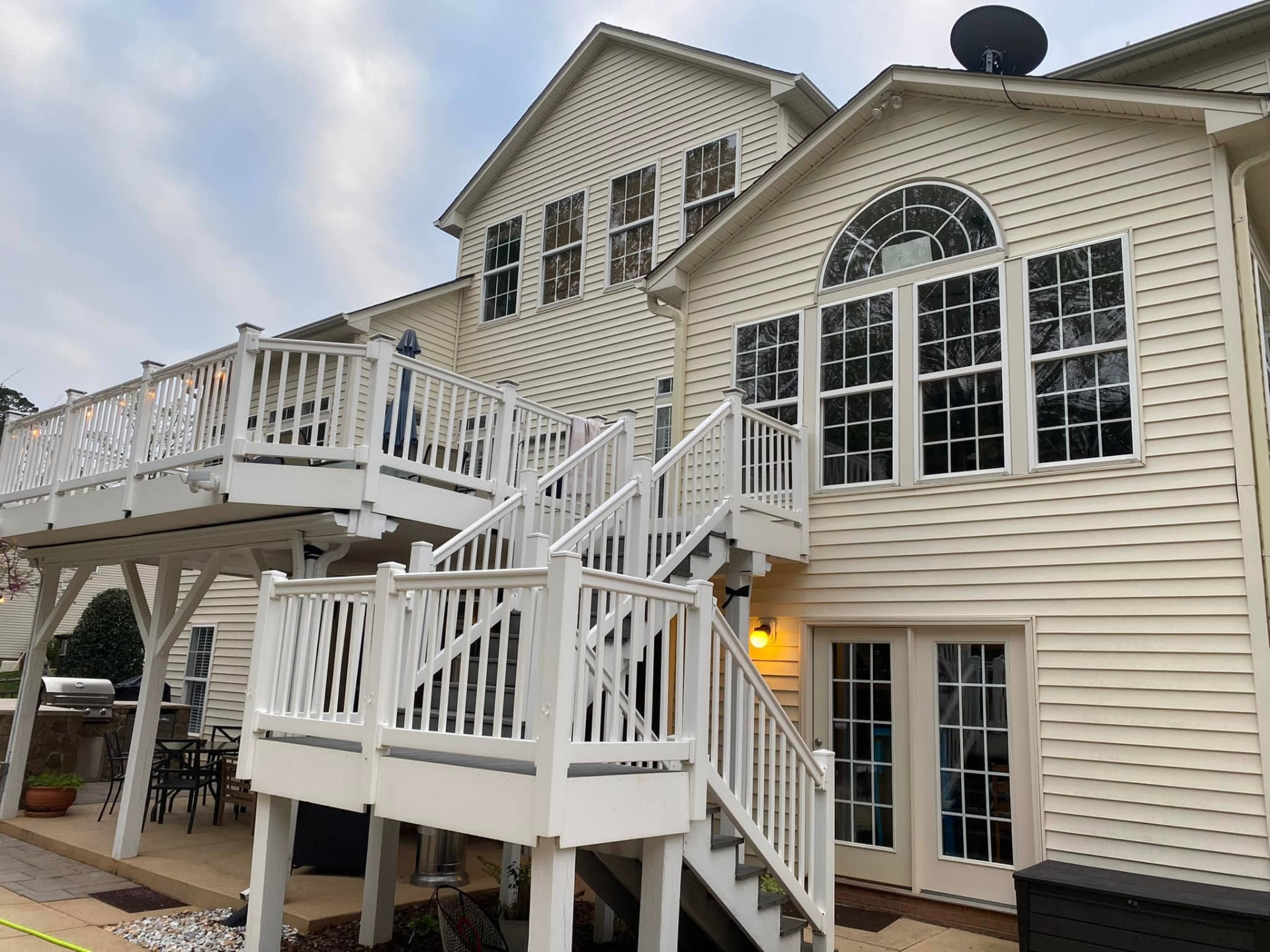 Clean residential siding and white exterior stairs after washing